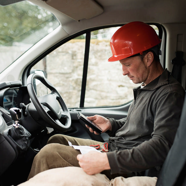 Technician using smartphone for completing work orders